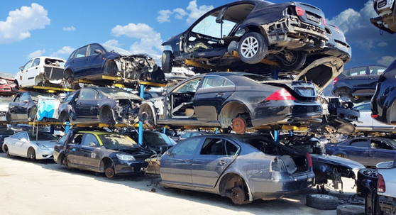 Accident damaged cars are stocked in a junkyard