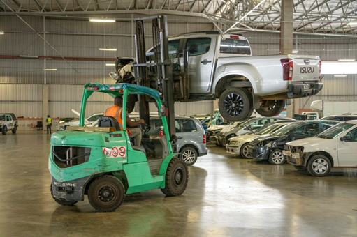 A crashed car is moved around the SYDC showroom