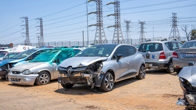 Rows of accident-damaged cars in a salvage yard in South Africa.